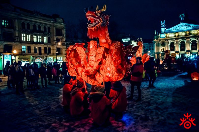 people holding large chinese dragon
